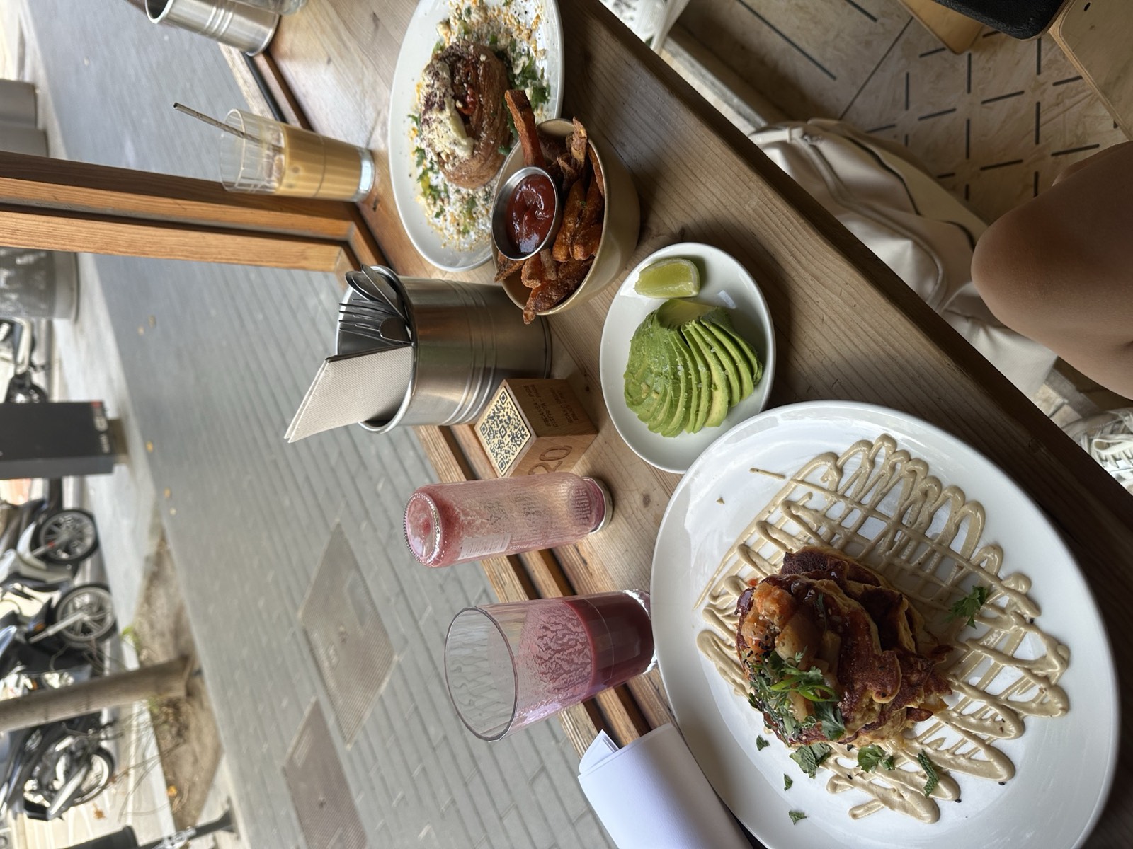 Breakfast by a window: toast, avocado and pink juices